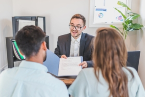 Man presents contract to couple